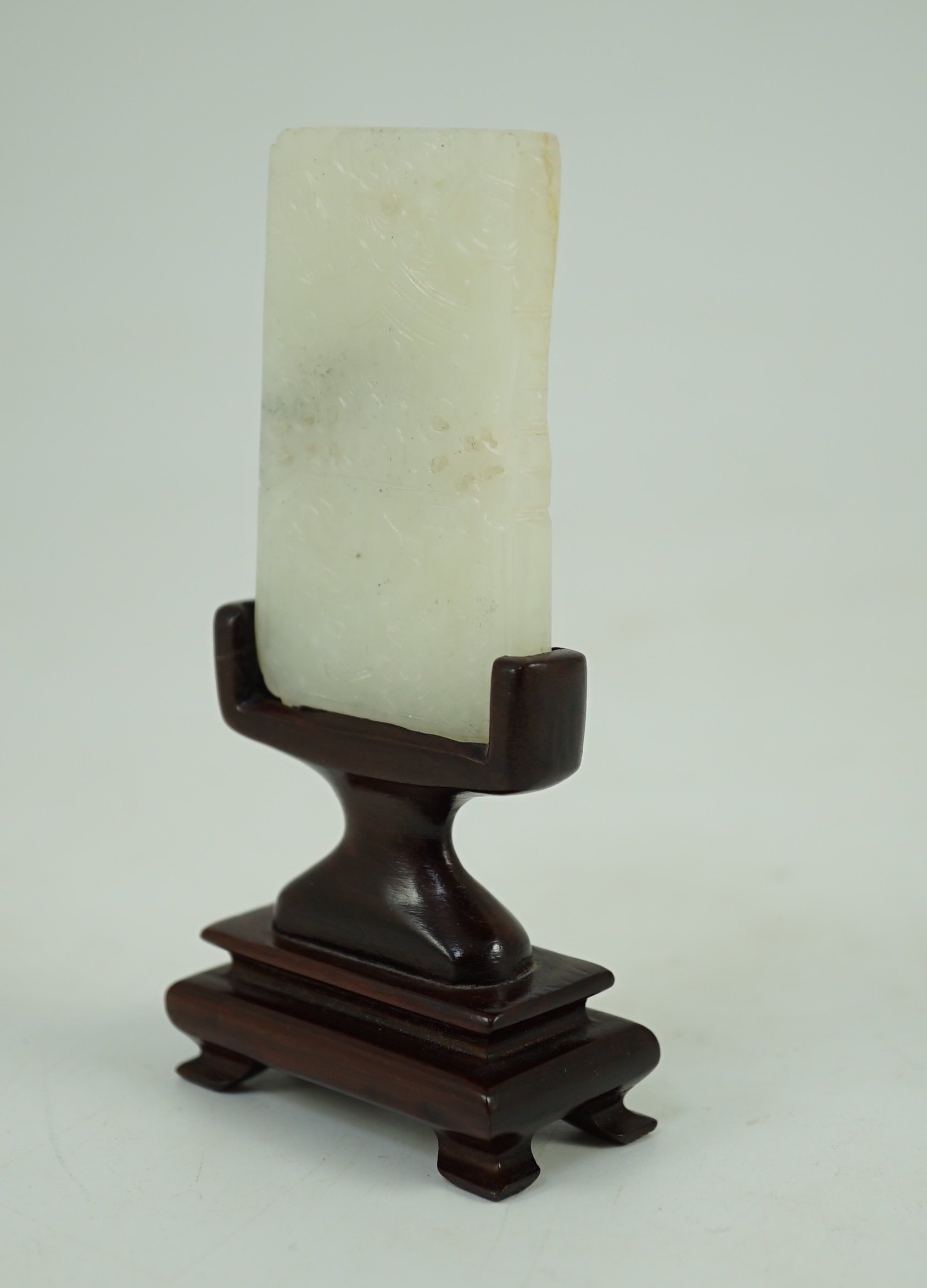 A Chinese inscribed white jade plaque, 19th century, 6.3 cm high, excluding wood stand